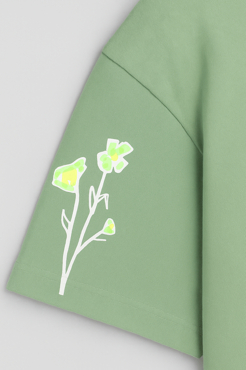 Green fabric with a floral design on a light gray background